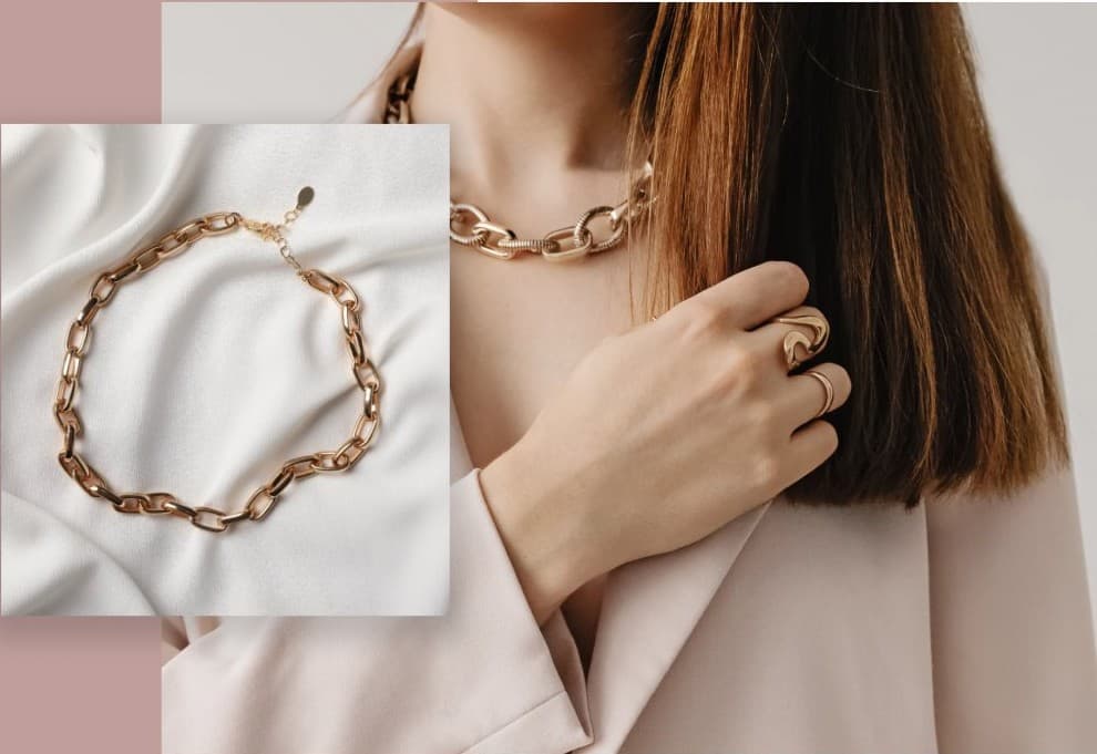 Gold link chain bracelet and a model wearing Daval jewellery